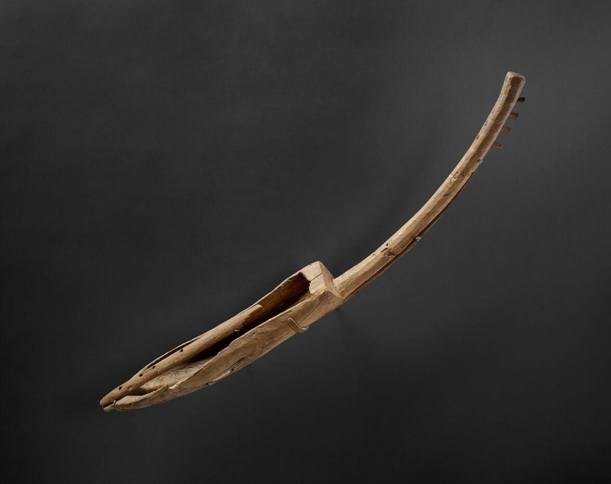 A surviving ancient wooden harp, with its arched frame and tuning pegs